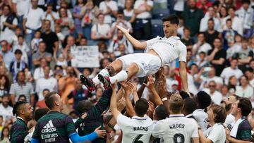 Marco Asensio is blanketed by his Real Madrid teammates at the end of the match against Athletic