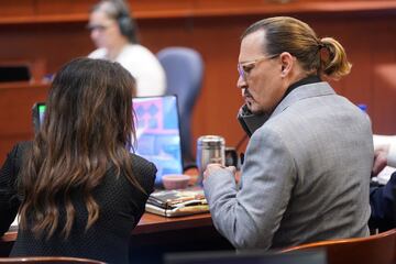 Depp speaks with a member of his legal team during his $50 million defamation case against ex-wife Amber Heard at the Fairfax County Circuit Courthouse in Fairfax, Virginia.