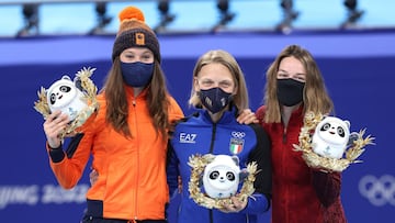 BEIJING, CHINA - FEBRUARY 07: Gold medallist Arianna Fontana of Team Italy (C), Silver medallist Suzanne Schulting of Team Netherlands (L) and Bronze medallist Kim Boutin of Team Canada  (R) pose with Bing Dwen Dwen mascots during the Women&#039;s 500m fl