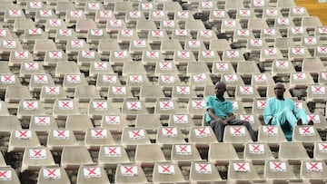 Fans sit on marked seats to adhere to social distancing measures to curb the spread of COVID-19 during the African Cup of Nations (AFCON) qualifying match between Nigeria and Lesotho at Teslim Balogun Stadium in Lagos on March 30, 2021. (Photo by PIUS UTO