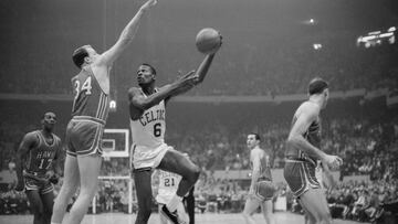 Boston Celtics' player Bill Russell hooks a shot during the NBA championship's final game in 1960 against the Saint Louis Hawks.