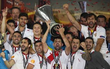 Sevilla's Coke celebrates with the Europa League trophy and team mates after winning the final against Liverpool in 2016