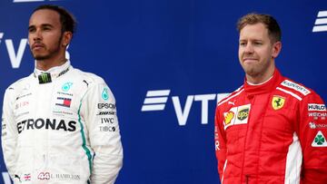 SOCHI, RUSSIA - SEPTEMBER 30: Race winner Lewis Hamilton of Great Britain and Mercedes GP and third placed Sebastian Vettel of Germany and Ferrari look on, on the podium during the Formula One Grand Prix of Russia at Sochi Autodrom on September 30, 2018