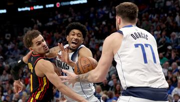 DALLAS, TEXAS - JANUARY 18: Trae Young #11 of the Atlanta Hawks scrambles for the ball against Christian Wood #35 of the Dallas Mavericks and Luka Doncic #77 of the Dallas Mavericks in the second quarter at American Airlines Center on January 18, 2023 in Dallas, Texas. NOTE TO USER: User expressly acknowledges and agrees that, by downloading and or using this photograph, User is consenting to the terms and conditions of the Getty Images License Agreement.   Tom Pennington/Getty Images/AFP (Photo by TOM PENNINGTON / GETTY IMAGES NORTH AMERICA / Getty Images via AFP)