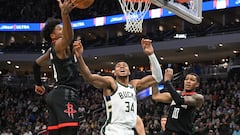 Milwaukee Bucks forward Giannis Antetokounmpo (34) battles for a rebound with Houston Rockets guard Jalen Green (4)