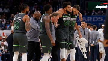 Nov 28, 2022; Washington, District of Columbia, USA; Minnesota Timberwolves center Karl-Anthony Towns (32) is helped off the court by Timberwolves center Rudy Gobert (27) and a member of the Timberwolves staff after being injured against the Washington Wizards in the third quarter at Capital One Arena. Mandatory Credit: Geoff Burke-USA TODAY Sports