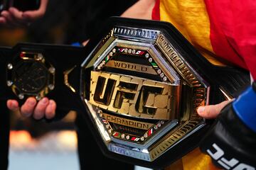 El cinturón de campeón de la UFC rodea el cuerpo de Ilia Topuria.