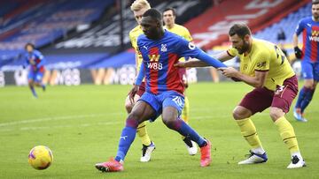 Crystal Palace's Christian Benteke, left, and Burnley's Erik Pieters challenge for the ball during the English Premier League soccer match between Crystal Palace and Burnley at Selhurst Park stadium in London, England, Saturday, Feb. 13, 2021. (