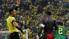 US referee Ismail Elfath (L) shows a red card to Cameroon's forward #10 Vincent Aboubakar after he takes his shirt off and earns a second yellow after scoring their goal during the Qatar 2022 World Cup Group G football match between Cameroon and Brazil at the Lusail Stadium in Lusail, north of Doha on December 2, 2022. (Photo by Issouf SANOGO / AFP) (Photo by ISSOUF SANOGO/AFP via Getty Images)