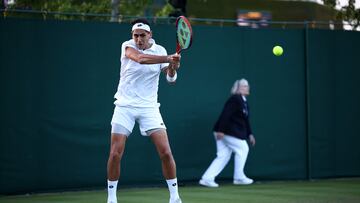 Chile's Alejandro Tabilo returns to Britain's Daniel Evans during their men's singles match on the second day of the 2024 Wimbledon Championships
