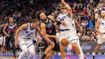 Nov 28, 2025; Detroit, Michigan, USA; Orlando Magic forward Franz Wagner (22) and guard Desmond Bane (3) defends against Detroit Pistons guard Cade Cunningham (2) in the second half of the annual in-season NBA Cup tournament at Little Caesars Arena. Mandatory Credit: David Reginek-Imagn Images