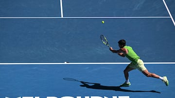 Spain's Carlos Alcaraz hits a shot against France's Corentin Moutet during their men's singles match on day six of the Australian Open tennis tournament in Melbourne on January 23, 2026. (Photo by WILLIAM WEST / AFP) / -- IMAGE RESTRICTED TO EDITORIAL USE - STRICTLY NO COMMERCIAL USE --