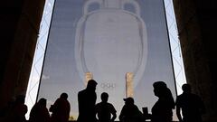 Spectators wait by a giant print of the Euro 2024 trophy prior to the start of the UEFA Euro 2024 round of 16 football match between Switzerland and Italy at the Olympiastadion Berlin in Berlin on June 29, 2024. (Photo by JOHN MACDOUGALL / AFP)