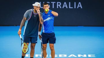 Serbia's Novak Djokovic (R) speaks with Australia's Nick Kyrgios before a point during their men's doubles match against Michael Venus of New Zealand and Nikola Mektic of Croatia at the Brisbane International tennis tournament in Brisbane on January 1, 2025. (Photo by Patrick HAMILTON / AFP) / --IMAGE RESTRICTED TO EDITORIAL USE - STRICTLY NO COMMERCIAL USE--