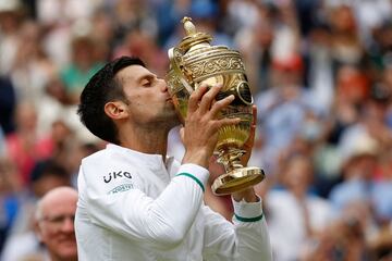 Serbia's Novak Djokovic kisses the winner's trophy after beating Italy's Matteo Berrettini during their men's singles final match on the thirteenth day of the 2021 Wimbledon Championships at The All England Tennis Club in Wimbledon, southwest London, on J