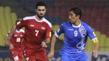 El autor del gol de Siria Khribin disputa un bal&oacute;n con el uzbeko Odil.
