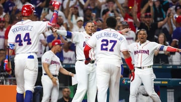 MIAMI, FLORIDA - MARCH 13: Vladimir Guerrero Jr. #27 of Team Dominican Republic celebrates scoring with teammates Julio Rodr�guez #44 (L) and Manny Machado #3 (C) in the second inning of the quarterfinal game against Team Korea in the 2026 World Baseball Classic at loanDepot park on March 13, 2026 in Miami, Florida. Al Bello/Getty Images/AFP (Photo by AL BELLO / GETTY IMAGES NORTH AMERICA / Getty Images via AFP)