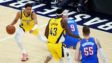 Jun 11, 2025; Indianapolis, Indiana, USA; Indiana Pacers guard Tyrese Haliburton (0) handles the ball against Oklahoma City Thunder guard Alex Caruso (9) during the second quarter in game three of the 2025 NBA Finals at Gainbridge Fieldhouse. Mandatory Credit: Trevor Ruszkowski-Imagn Images