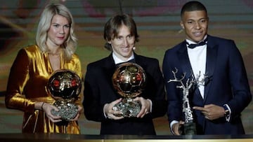 Luka Modric with his Ballon d'Or, alongside women's Ballon d'Or winner, Ada Hegerberg, and young player of the year, Kylian Mbappé at the awards gala in December.