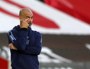 Manchester City's Spanish manager Pep Guardiola looks on from the sidelines.