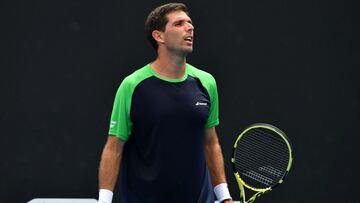 Argentina's Federico Delbonis reacts on a point against Spain's Pedro Martinez during their men's singles match on day one of the Australian Open tennis tournament in Melbourne on January 17, 2022. (Photo by Paul Crock / AFP) / -- IMAGE RES