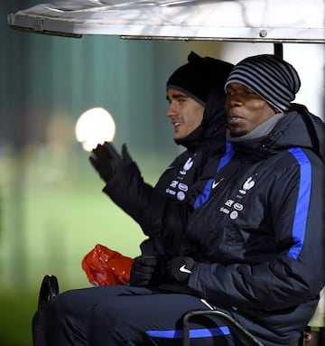 Antoine Griezmann and France's midfielder Paul Pogba leave a training session in Clairefontaine-en-Yvelines.