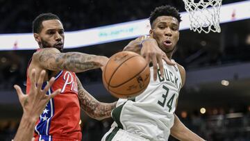 Feb 22, 2020; Milwaukee, Wisconsin, USA; Philadelphia 76ers forward Mike Scott (1) and Milwaukee Bucks forward Giannis Antetokounmpo (34) battle for a rebound in the third quarter at Fiserv Forum. Mandatory Credit: Benny Sieu-USA TODAY Sports