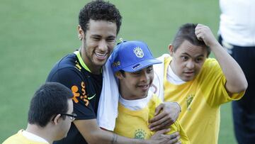 Neymar abraza a dos j&oacute;venes admiradores con s&iacute;ndrome de Down durante una sesi&oacute;n de entrenamiento de la selecci&oacute;n brasile&ntilde;a.