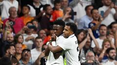 Real Madrid's Brazilian forward Vinicius Junior celebrates with Real Madrid's Brazilian forward Rodrygo scoring his team's first goal during the UEFA Champions League semi-final first leg football match between Real Madrid CF and Manchester City at the Santiago Bernabeu stadium in Madrid on May 9, 2023. (Photo by OSCAR DEL POZO / AFP)