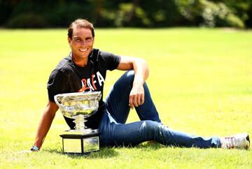 Rafa Nadal poses with the Norman Brookes Challenge Cup after winning the 2022 Australian Open men's singles final.