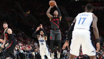 Nov 28, 2018; Portland, OR, USA; Portland Trail Blazers guard Damian Lillard (0) shoots a three-point shot over Orlando Magic guard D.J. Augustin (14) in the second half at Moda Center. Mandatory Credit: Jaime Valdez-USA TODAY Sports