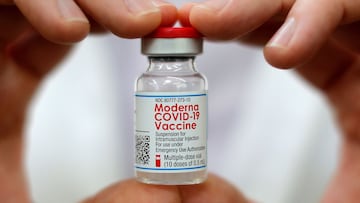 FILE PHOTO: Walmart pharmacist holds a vial of the Moderna coronavirus disease (COVID-19) vaccine inside a Walmart department store in West Haven, Connecticut, U.S., February 17, 2021. REUTERS/Mike Segar/File Photo