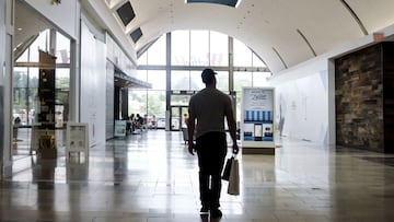 A person carries shopping bags in a mall in Paramus, New Jersey.