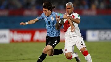 Soccer Football - World Cup - South American Qualifiers - Uruguay v Peru - Estadio Centenario, Montevideo, Uruguay - March 24, 2022 Uruguay's Facundo Pellistri in action with Peru's Miguel Trauco Pool via REUTERS/Matilde Campodonico