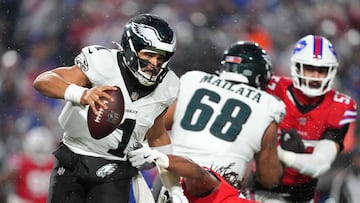ORCHARD PARK, NEW YORK - DECEMBER 28: Jalen Hurts #1 of the Philadelphia Eagles sheds a tackle from Dorian Williams #42 of the Buffalo Bills during the third quarter of the game at Highmark Stadium on December 28, 2025 in Orchard Park, New York. Nic Antaya/Getty Images/AFP (Photo by Nic Antaya / GETTY IMAGES NORTH AMERICA / Getty Images via AFP)
