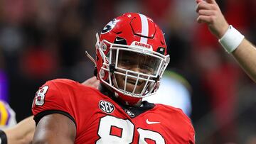 (FILES) In this file photo taken on December 3, 2022, Jalen Carter of the University of Georgia Bulldogs in action against the LSU Tigers during the SEC Championship at Mercedes-Benz Stadium in Atlanta, Georgia. - Police in Georgia issued an arrest warrant for Carter, one of the top prospects in the upcoming NFL draft, US media reported on March 1. 2023. Carter, a defensive lineman and widely viewed as a likely top five NFL draft pick, was issued the warrant by the Athens-Clarke County Police Department in relation to a fatal car accident. (Photo by Kevin C. COX / GETTY IMAGES NORTH AMERICA / AFP)