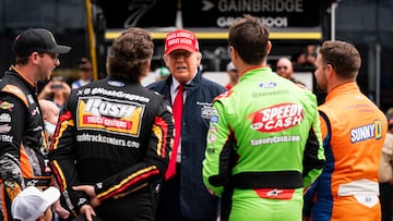 US President Donald Trump greets drivers prior to riding in the Presidential limousine ahead of the start of the Daytona 500 Nascar race at Daytona International Speedway in Daytona Beach, Florida, on Sunday, February 16, 2025. (Photo by Al DRAGO / POOL / AFP)