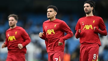 Liverpool's Argentinian midfielder #10 Alexis Mac Allister (L), Liverpool's Colombian midfielder #07 Luis Diaz and Liverpool's Hungarian midfielder #08 Dominik Szoboszlai warm up ahead of the English Premier League football match between Manchester City and Liverpool at the Etihad Stadium in Manchester, north west England, on February 23, 2025. (Photo by Paul ELLIS / AFP) / RESTRICTED TO EDITORIAL USE. No use with unauthorized audio, video, data, fixture lists, club/league logos or 'live' services. Online in-match use limited to 120 images. An additional 40 images may be used in extra time. No video emulation. Social media in-match use limited to 120 images. An additional 40 images may be used in extra time. No use in betting publications, games or single club/league/player publications. /
