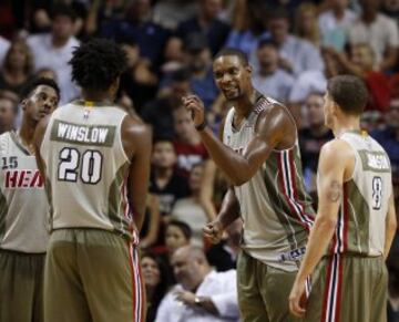 Chris Bosh habla con Justise Winslow, Tyler Johnson y Mario Chalmers.