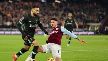 Liverpool's Egyptian striker #11 Mohamed Salah battles for the ball with West Ham United's Mexican midfielder #19 Edson Alvarez during the English Premier League football match between West Ham United and Liverpool at the London Stadium, in London on December 29, 2024. (Photo by Adrian Dennis / AFP) / RESTRICTED TO EDITORIAL USE. No use with unauthorized audio, video, data, fixture lists, club/league logos or 'live' services. Online in-match use limited to 120 images. An additional 40 images may be used in extra time. No video emulation. Social media in-match use limited to 120 images. An additional 40 images may be used in extra time. No use in betting publications, games or single club/league/player publications. /