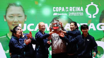 El equipo celebra la victoria alzando el trofeo.