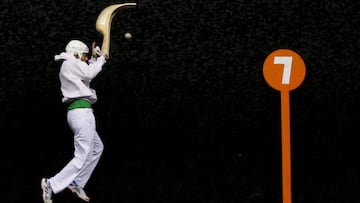 A Jai Alai player jumps high with his chistera, a large wicker glove, for the pelota during a Cesta Punta match in Anglet in the Basque country, France, January 30, 2019. Picture taken January 30, 2019. REUTERS/Regis Duvignau