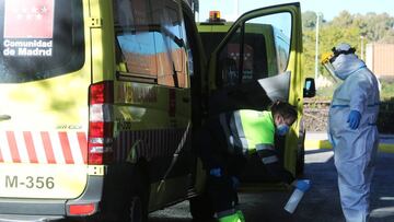 An ambulance worker wearing a full personal protective equipment (PPE) is disinfected by a collage outside the emergency unit of Severo Ochoa hospital amid the coronavirus disease (COVID-19) outbreak in Leganes, outside Madrid, Spain, October 16, 2020. REUTERS/Sergio Perez