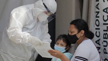 Medical staff attend to a mother and daughter outside the T-III Dr. Juan Duque de Estrada Health Centre in Mexico City. (Photo by Gerardo Vieyra/NurPhoto via Getty Images)