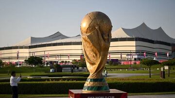 A man takes a picture of a FIFA World Cup trophy replica in front of the Al-Bayt Stadium in al-Khor on November 10, 2022, ahead of the Qatar 2022 FIFA World Cup football tournament. (Photo by Kirill KUDRYAVTSEV / AFP) (Photo by KIRILL KUDRYAVTSEV/AFP via Getty Images)