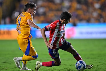 Fernando Gorriaran (L) of Tigres fights for the ball with Juan Sanabria (R) of San Luis during the 7th round match between Tigres UANL and Atletico San Luis as part of the Liga BBVA MX, Torneo Apertura 2024 at Universitario Stadium on September 13, 2024 in Monterrey, Nuevo Leon, Mexico.