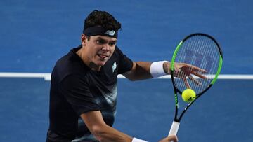 Canada's Milos Raonic hits a return against Spain's Roberto Bautista Agut during their men's singles fourth round match on day eight of the Australian Open tennis tournament in Melbourne on January 23, 2017. / AFP PHOTO / GREG WOOD / IMAGE RESTRICTED TO EDITORIAL USE - STRICTLY NO COMMERCIAL USE