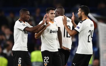 Geoffrey Kondogbia, Maximiliano Gomez and Ezequiel Garay of Valencia celebrate after the UEFA Champions League group H match between Chelsea FC and Valencia CF at Stamford Bridge