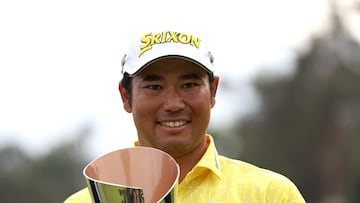 Hideki Matsuyama of Japan poses for a photo with the trophy after putting in to win on the 18th green during the final round of The Genesis Invitational at Riviera Country Club.