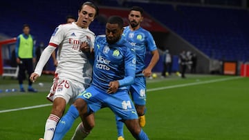 Lyon's French midfielder Maxence Caqueret (L) challenges Marseille's French defender Jordan Amavi during the French L1 football match between Olympique Lyonnais and Olympique de Marseille at the Groupama Stadium in Decines-Charpieu, near Lyon, c